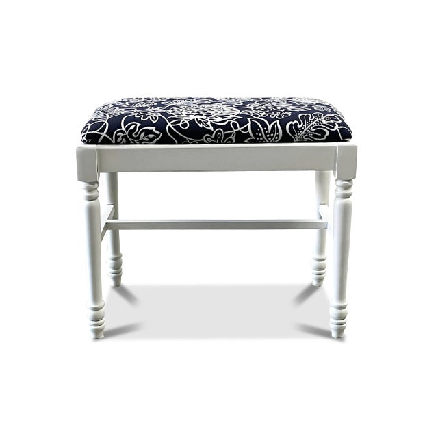 A small farmhouse upholstered bench that has been newly upholstered and painted a satin white. The vintage bench has a...