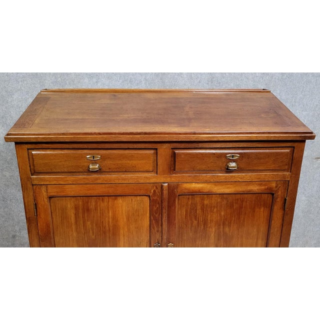 Late 19th-century stained solid beechwood writing desk with a slanted top Front opening with two doors and two drawers...