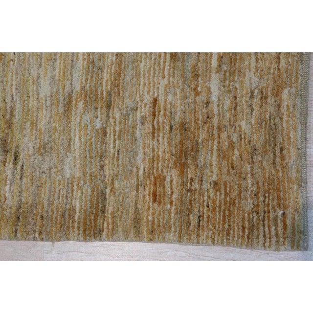 This hand knotted pile rug features a primary brown earth tone and is crafted from durable wool. Originating from India,...