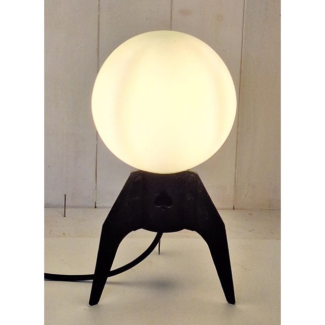 Mid-Century Table Lamp with a Black Iron Tripod Base and a White Opal Glass Shade, 1960s, in Very Good conditions....