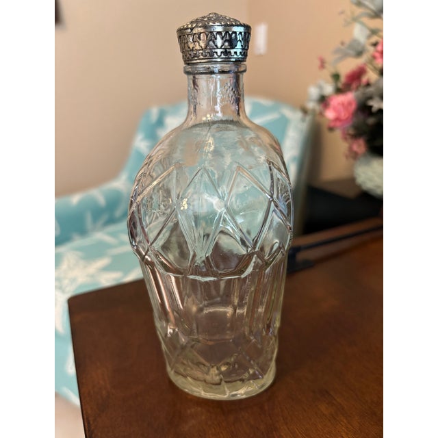 A handsome vintage Canadian liquor decanter bottle featuring an elegant paneled silhouette with embossed diamond and...