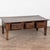 19th-century French walnut coffee table featuring a deep, richly aged patina resting on four straight lined legs. The...