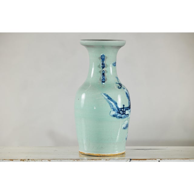 A tall and finely potted Chinese porcelain altar vase, decorated in underglaze cobalt blue on a pale celadon ground....