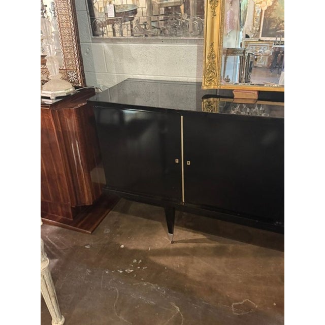 The MCM Italian Art Deco Design Black Lacquered Sideboard is a sleek and stylish piece of furniture perfect for adding a...