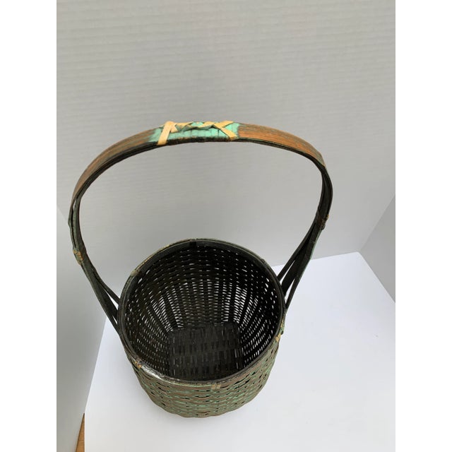 Elegant rustic wood decor and storage basket with elongated handle and soft sage gold patina. Asian chinoiserie style,...