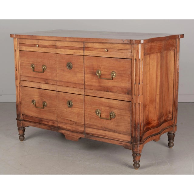 An early 19th Century French Directoire Period commode made of solid cherry wood with yellow pine as a secondary wood....