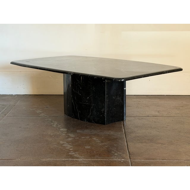 1980's postmodern black marble coffee table in good vintage condition. Small chips on the base. Minor scratches. Unsigned....