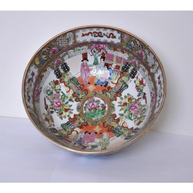 A Cantonese Famille Rose punch bowl, circa late 19th c. Decorated with alternate panels of figures including ladies and...