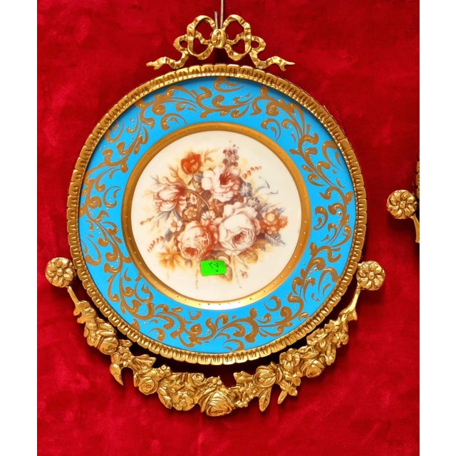 This elegant set of three Baroque-inspired wall art pieces features delicate floral artwork surrounded by beautiful sky...
