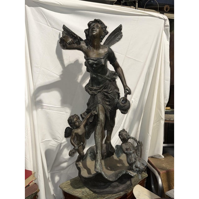 Antique bronze statue depicting a fairy with angels. A great decorative object.