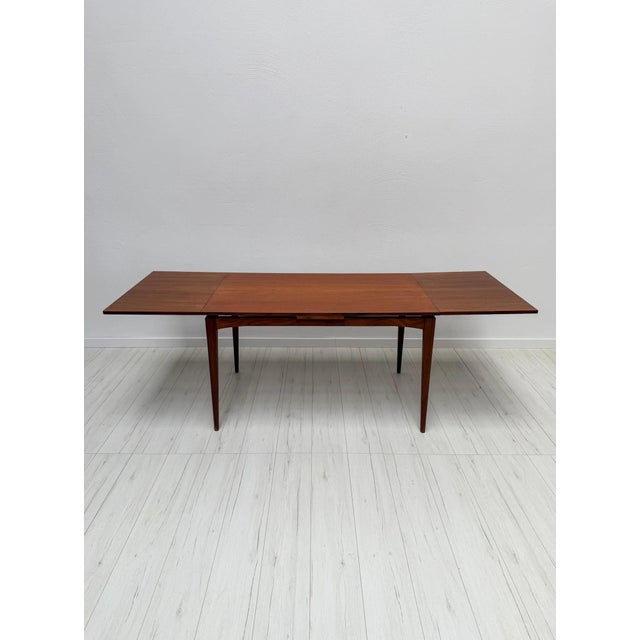 Elegant mid-century Teak dining table in Scandinavian design, dating from the 1960s. The table features a clean...