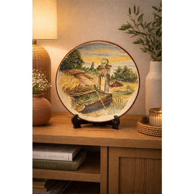 A decorative Vietri ceramic plate signed by Avallone, dating back to the 1950s. The work depicts a rural landscape with a...