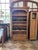 Charming rustic pine bookcase dating to circa 1900, featuring a beautifully shaped cornice, four adjustable interior...