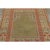 Hand-knotted in wool, this 4x6 Vintage Turkish Anatolian Prayer Rug, circa 1950–1959, features a serene olive mihrab...