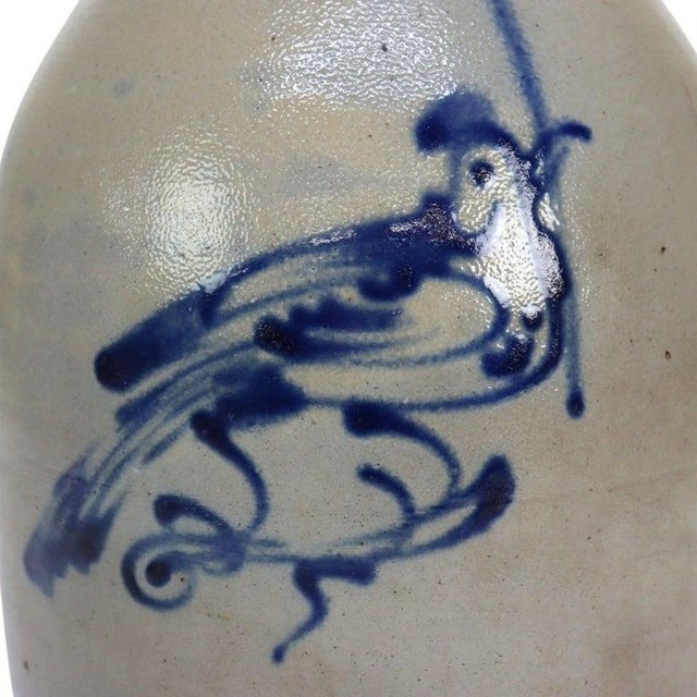 An antique West Troy Pottery salt-glazed stoneware jug, dating to approximately 1870. This piece features a distinctive...