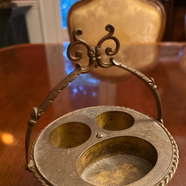 Unusual item made with a coconut shell, on 3 legs with anthemion feet, the top with 3 compartments, perhaps at one time...