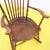 Wooden rocking chair featuring a beautifully turned backrest decoration.