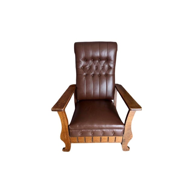 Antique 1900's "The Kelly Automatic Morris Reclining Chair". Quarter-Sawn Oak frame with wide flat arm rest and paw feet....