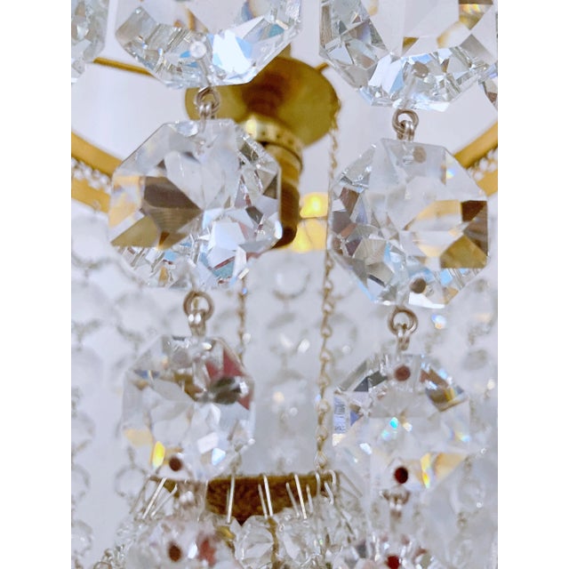 This is adorable vintage brass frame basket chandelier with graduated crystal chain. It has one Edison based socket that...