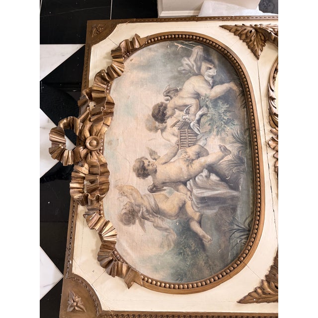 The Tall Gilded French Louis XV Style Trumeau Mirror with Cherubs is a stunning antique mirror with a gold frame finish...