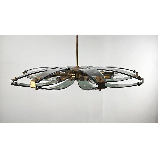Elegant Italian Mid-Century Modern chandelier attributed to Fontana Arte, dating from the late 1950s to 1960s. The fixture...