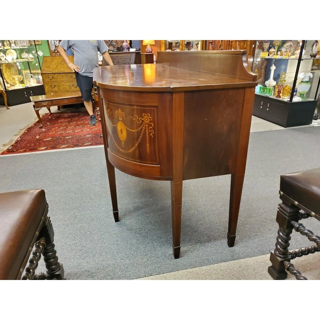 Gorgeous antique mahogany bow front sideboard in the Sheraton style. Consisting of two central drawers, with an open space...