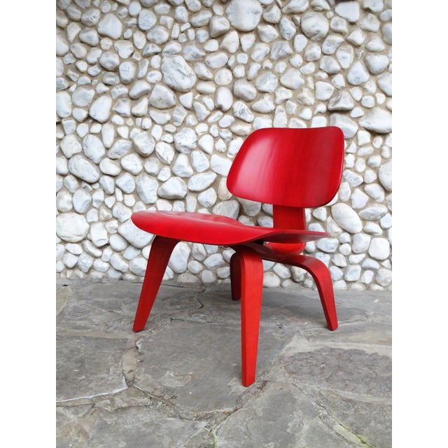 An early LCW (Lounge Chair Wood), restored, stained red as it was originally. Chair sold by Herman Miller, but produced by...