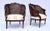 A pair of French Louis XVI style double caned Bergere chairs of classic European styling with carved wood frames, tight...