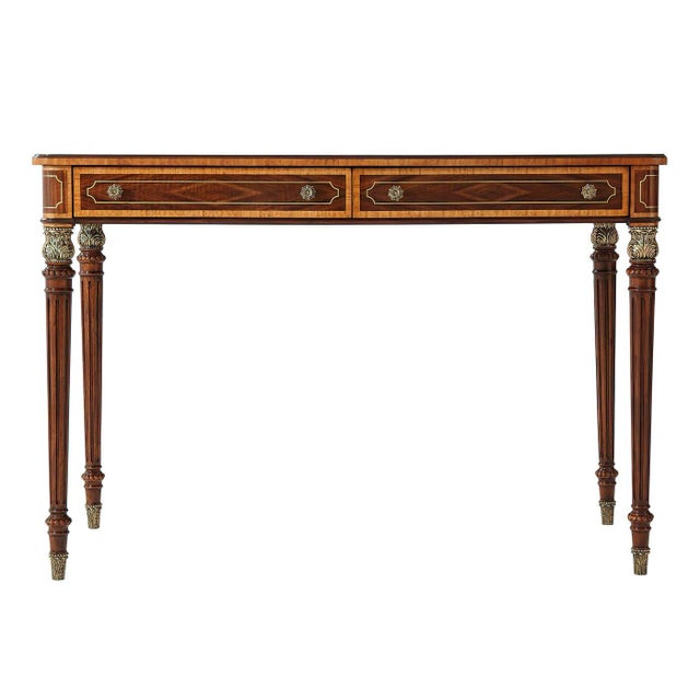 A fine inlaid Regency style writing table with two frieze drawers, turned and fluted legs that have acanthus cast brass...