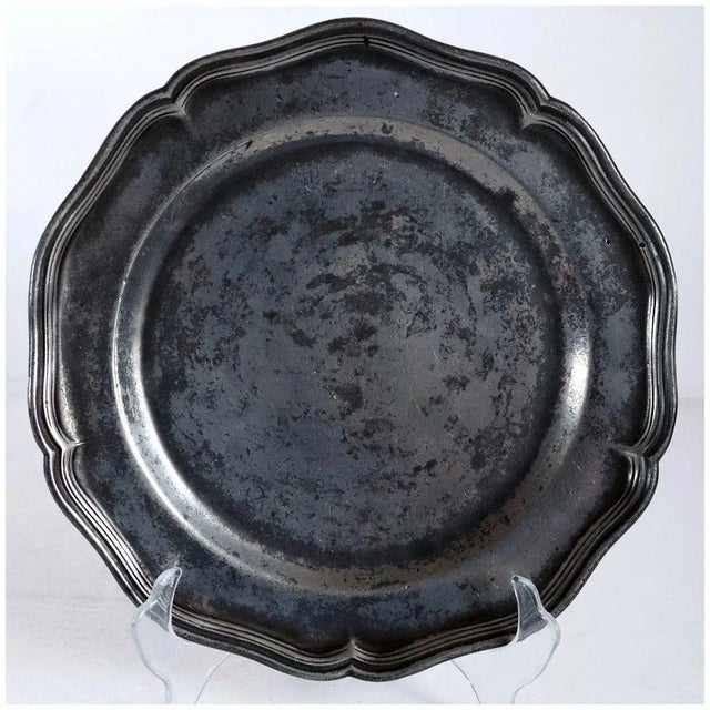 DETAILS An antique Continental plate of round shape with a wide wavy, multiple reeded edge rim. MARKS Stamped: crowned X,...