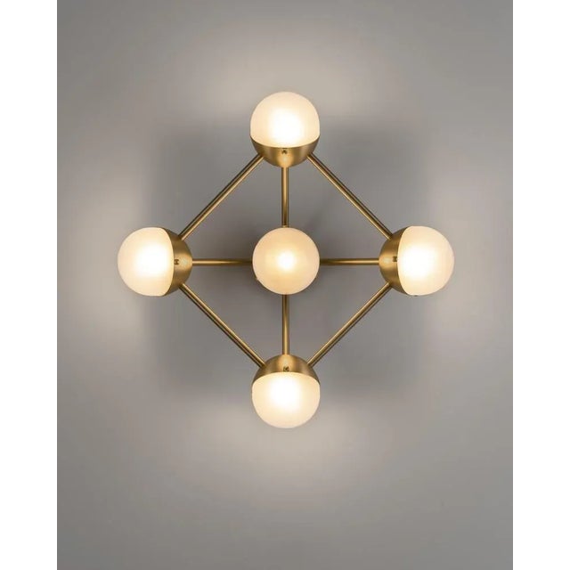 Molecule 5 wall sconce by schwung. Dimensions: w 58.4 x d 22.4 x h 58.4 cm. Materials: brass, glass, pn finish. Also...