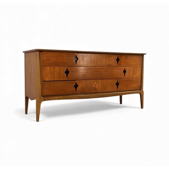 This hard-to-find 1960s lowboy dresser by United Furniture showcases a warm, understated Mid Century Modern profile with...