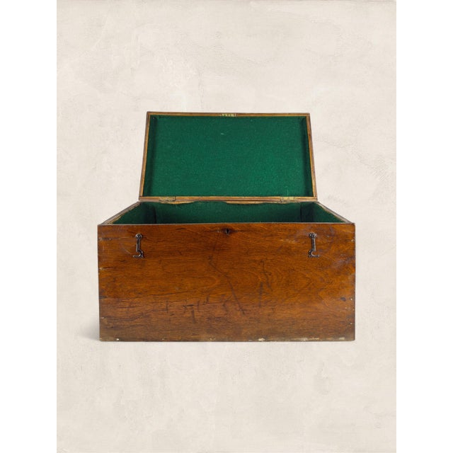 A handsome antique English oak storage box dating to circa 1910, featuring a rich timeworn patina and a traditional green...