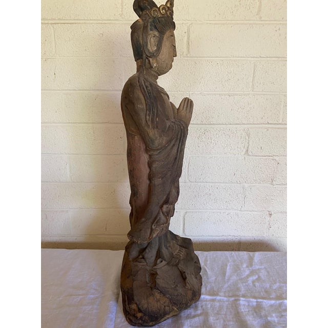 A beautifully hand‑carved wooden Bodhisattva figure, most likely representing Guanyin. This substantial 28‑inch statue...