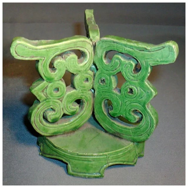 Antique Chinese porcelain stand in apple green. Three supports built up of scroll work all resting on a round plinth. Good...