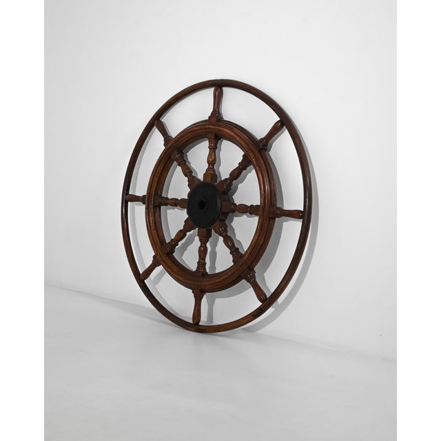 Capture the spirit of nautical history with this magnificent 1900s French wooden ship steering wheel. Crafted with...