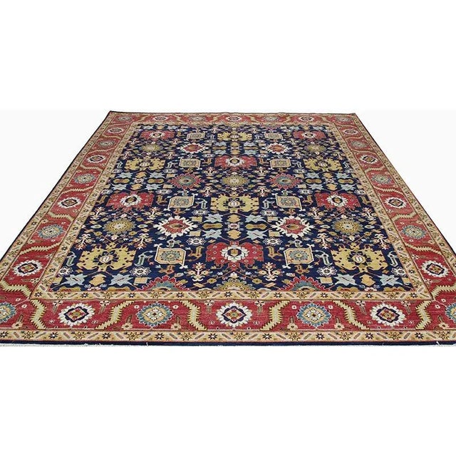ACTUAL SIZE: 9’2″ x 12’7″ PRIMARY COLOR: Navy / Red AGE: New ORIGIN: Pakistan MATERIALS: Wool FOUNDATION: Cotton...