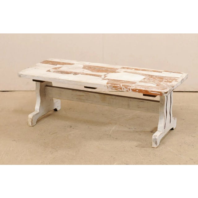 Rustic meets modern in this European Art Deco themed painted coffee table from the mid-20th century. A vintage coffee...
