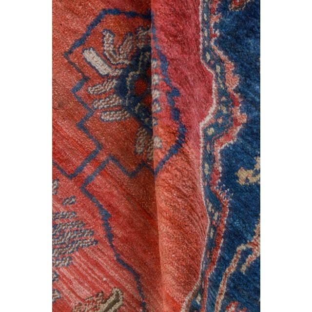 A late 19th century antique Persian carpet, the midnight blue field with palmettes and vinery between linked red and ivory...