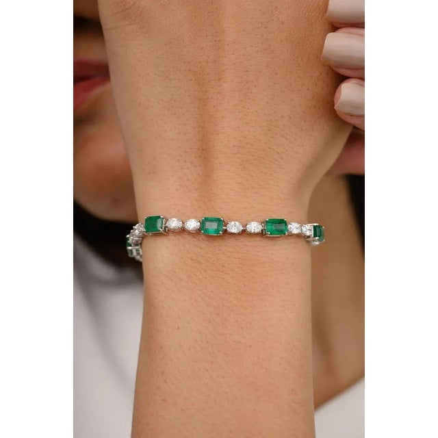 This is part of Chairish’s Fine Jewelry assortment. This Magnificent Emerald and Diamond Tennis Bracelet in 18K gold...