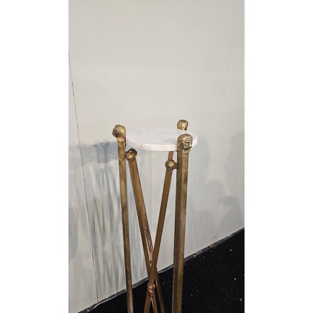 Pair of 3-legged brass pedestals with marble top, light patina due to age.