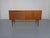 Small teak sideboard from the 1960s. Design by Heinrich Riestenpatt. Two doors with a shelf behind them. Three drawers on...