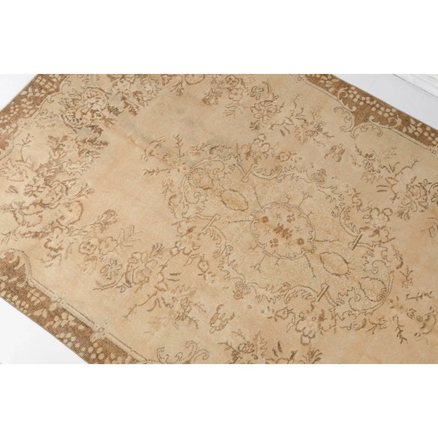 This is a vintage Turkish Oushak rug from the 1960s. The piece was hand-knotted.