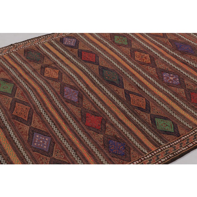 Made with handwoven wool circa 1950-1960, this 5x6 vintage Persian kilim, originating from the Larkhabi region of...
