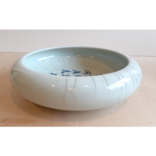 Chinese porcelain Guan Yao poetry bowl, a finely formed, shallow bowl with prounounced curving sides and a subtle, light...