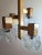 Original and peculiar chandelier made of gold-colored anodized aluminum; on a solid central bar with square sections are...