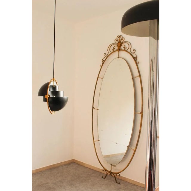 Oval mirror in art deco brass, Italia 1940s, large has a break in the lower part of the glass, the frame is in excellent...