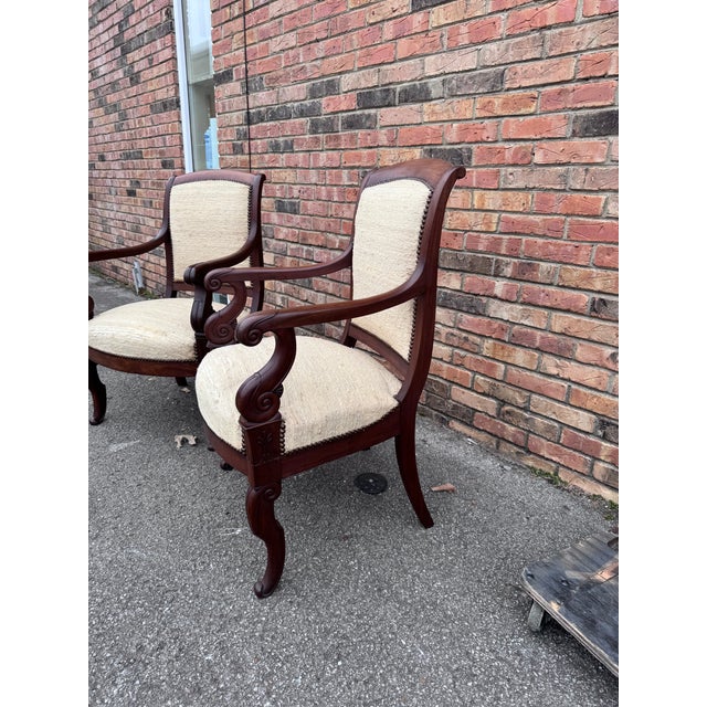 This is a pair of French Regency arm chairs with stunning millwork designs along the frame. They feature a beautiful...