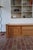 A long low storage unit in solid elm, produced by the French maker Camif, in the neo-rustic register that Maison Regain...