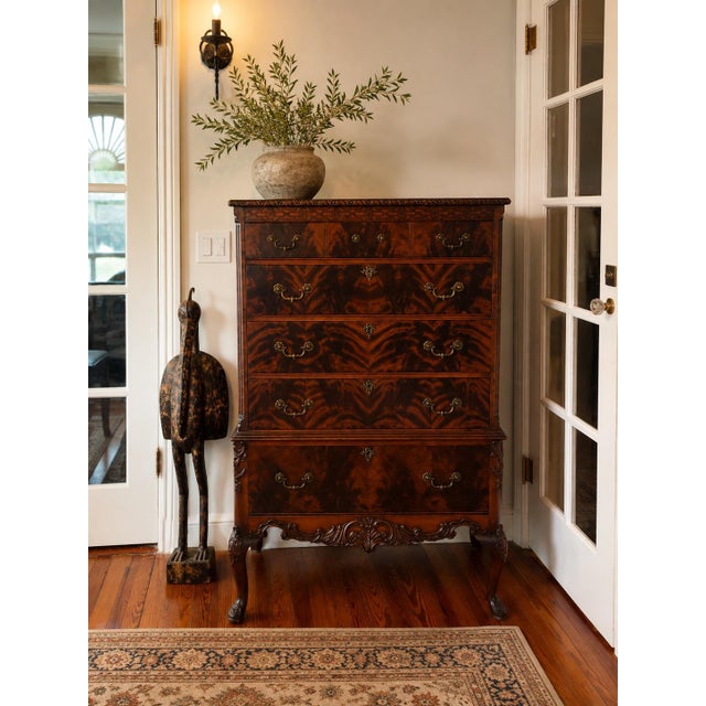 American Chippendale Revival high chest of drawers dating to approximately the 1920s–30s, constructed with richly figured...